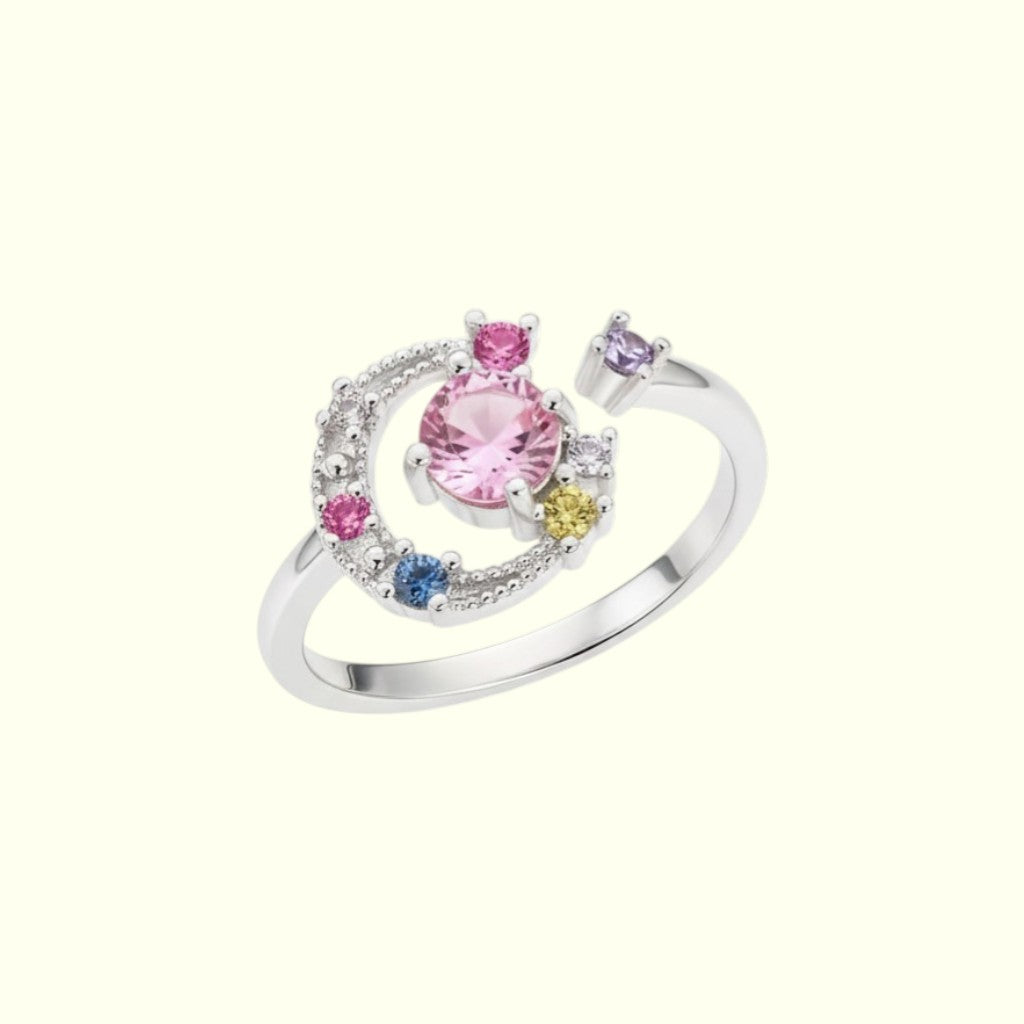 Silver ring with colorful gemstones on a white background