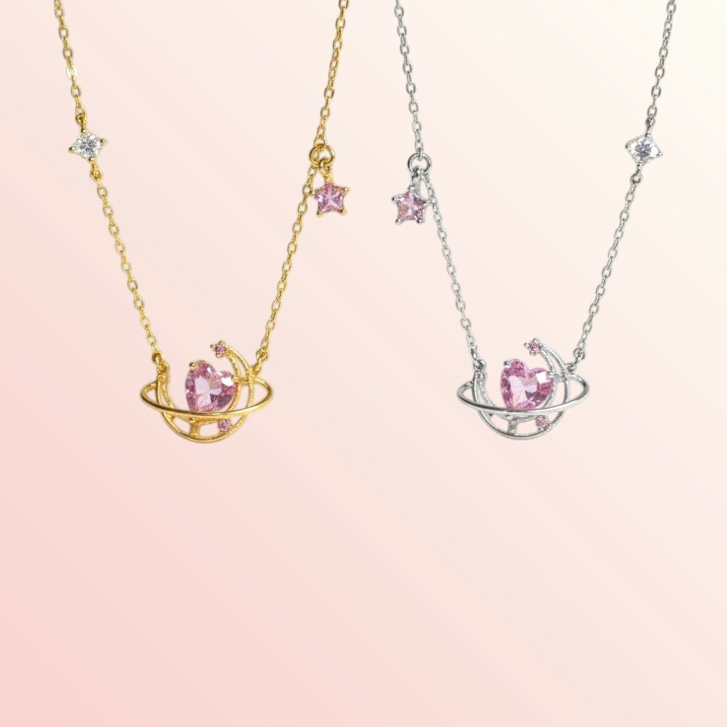 Two necklaces with pink gemstones on a light pink background