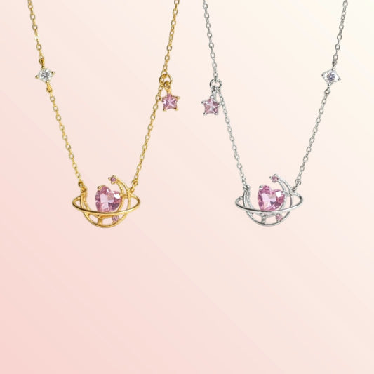 Two necklaces with pink gemstones on a light pink background