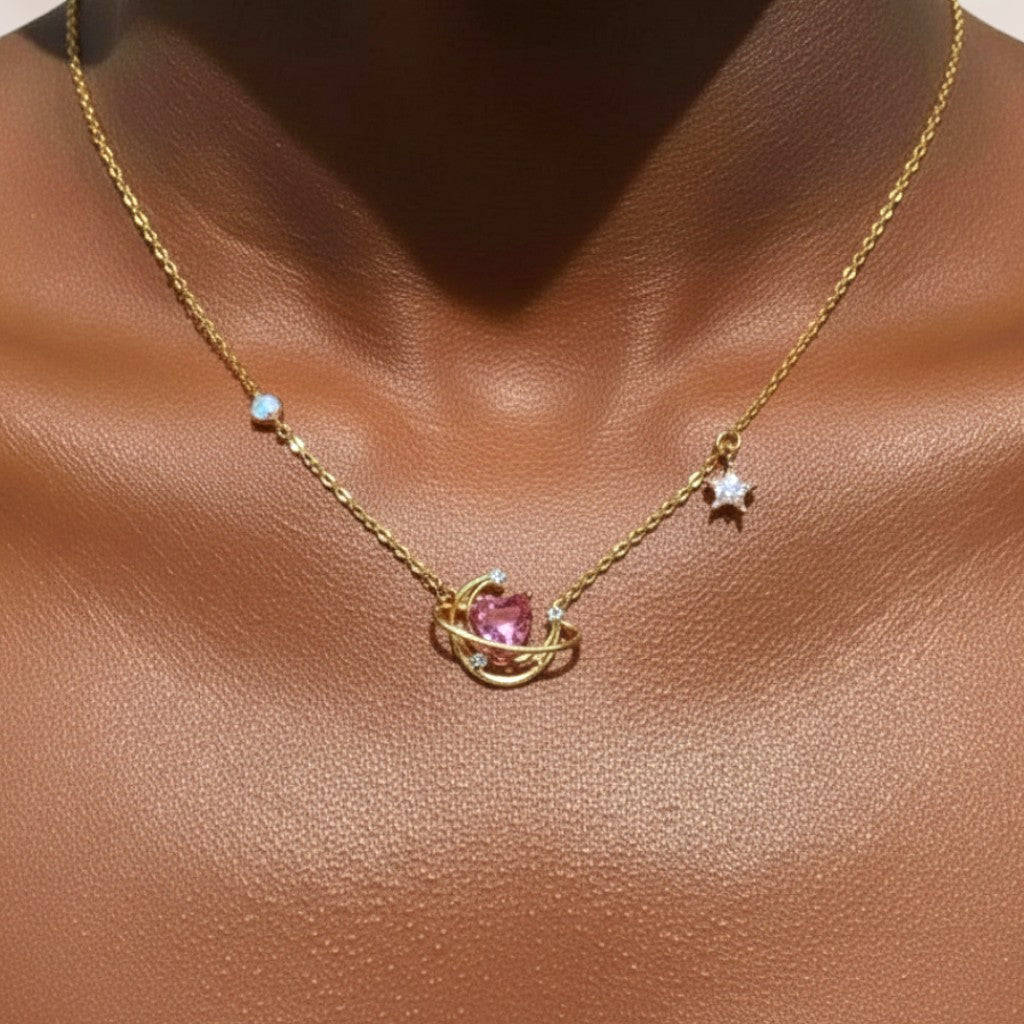 Gold necklace with a pink heart pendant on a brown background