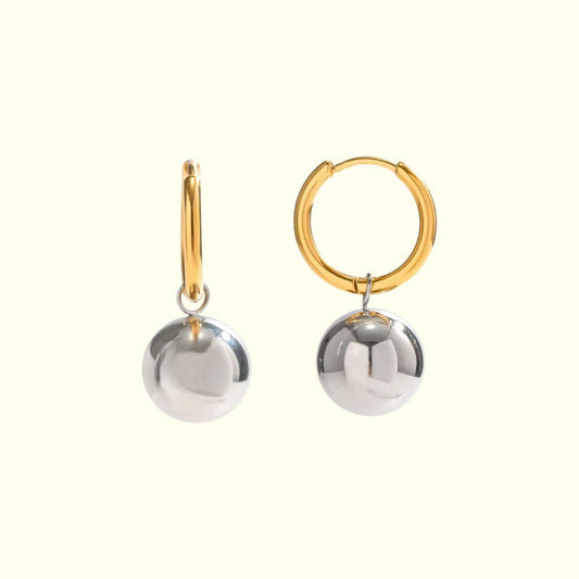 Pair of gold and silver hoop earrings on a white background