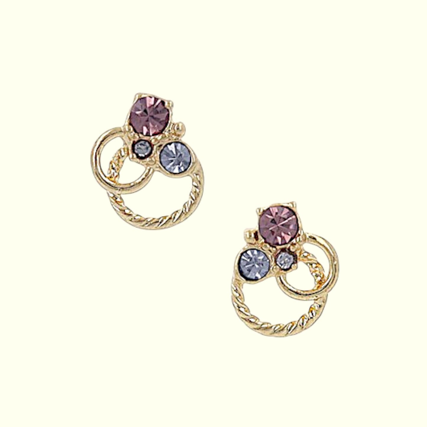 Gold hoop earrings with multicolored gemstones on a white background