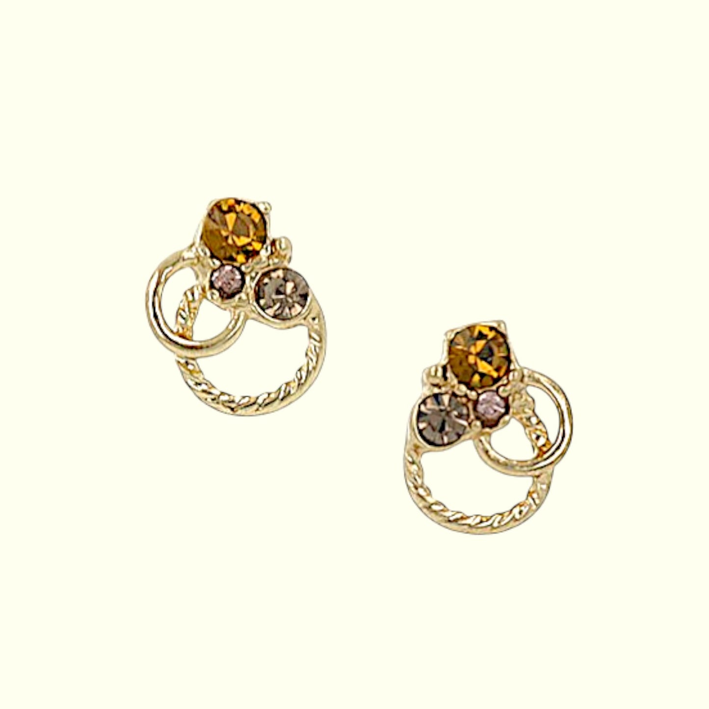 Gold earrings with gemstones on a white background