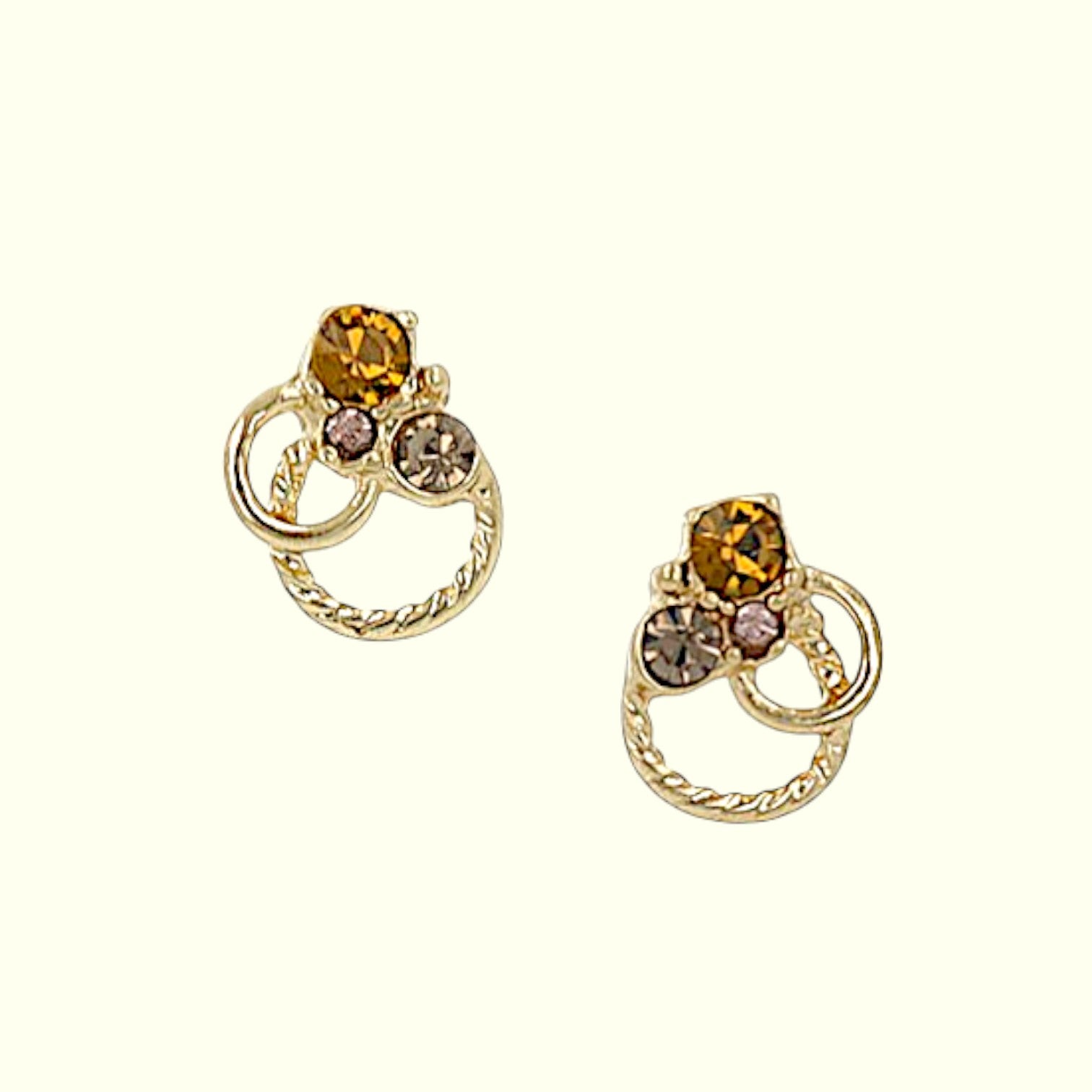 Gold earrings with gemstones on a white background