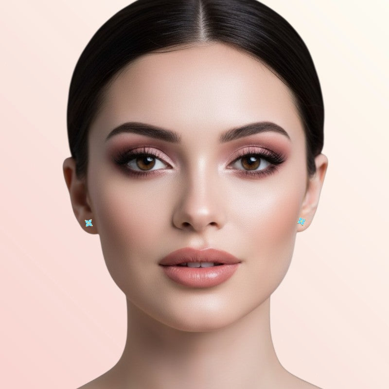 Woman wearing earrings on a beige background
