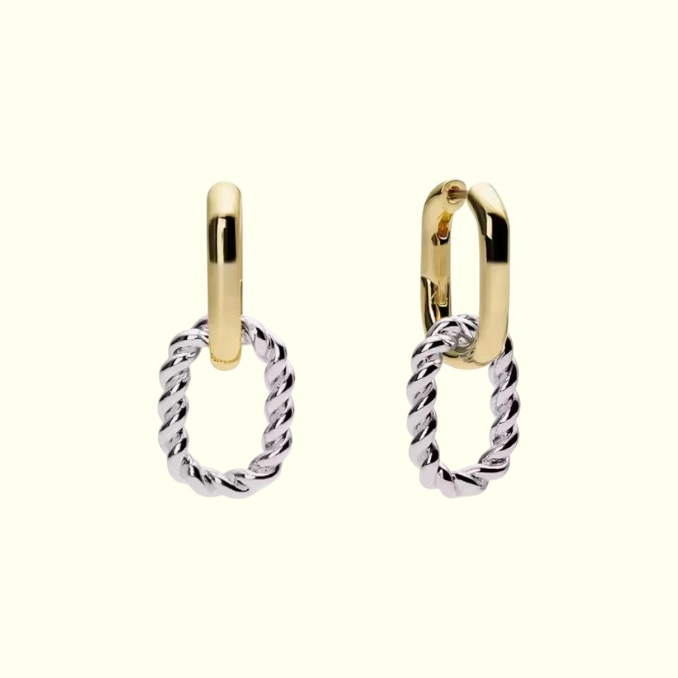 Pair of gold and silver hoop earrings on a white background