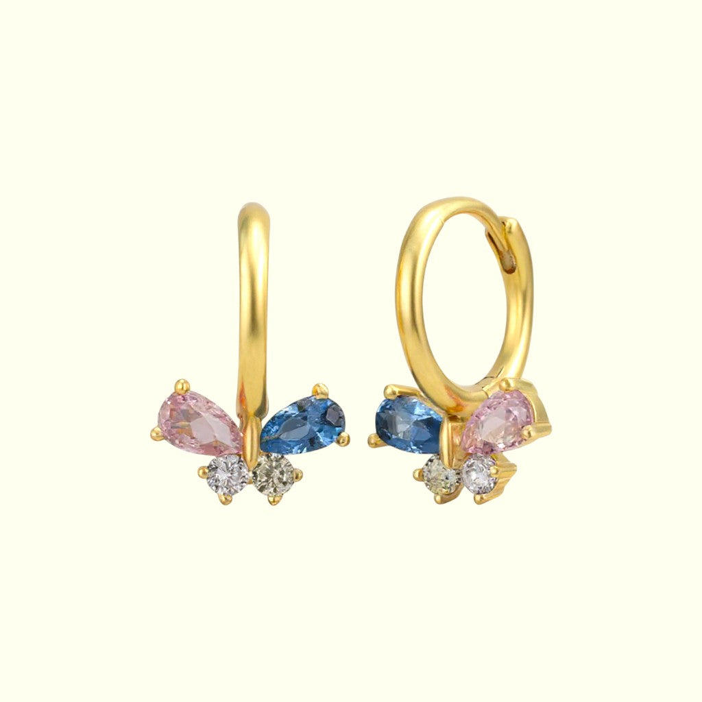 Gold hoop earrings with pink and blue gemstones on a white background