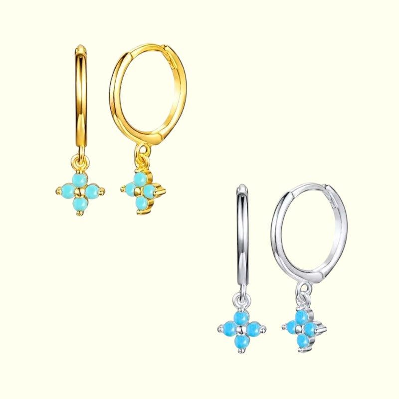 Pair of gold hoop earrings with turquoise flower charms on a white background