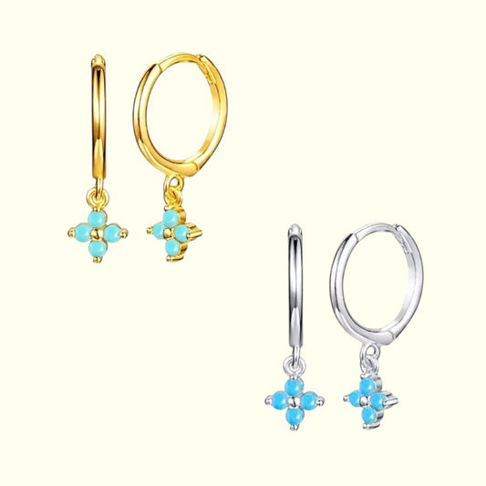 Pair of gold hoop earrings with turquoise flower charms on a white background