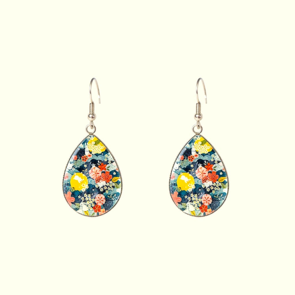 Teardrop-shaped floral earrings on a white background
