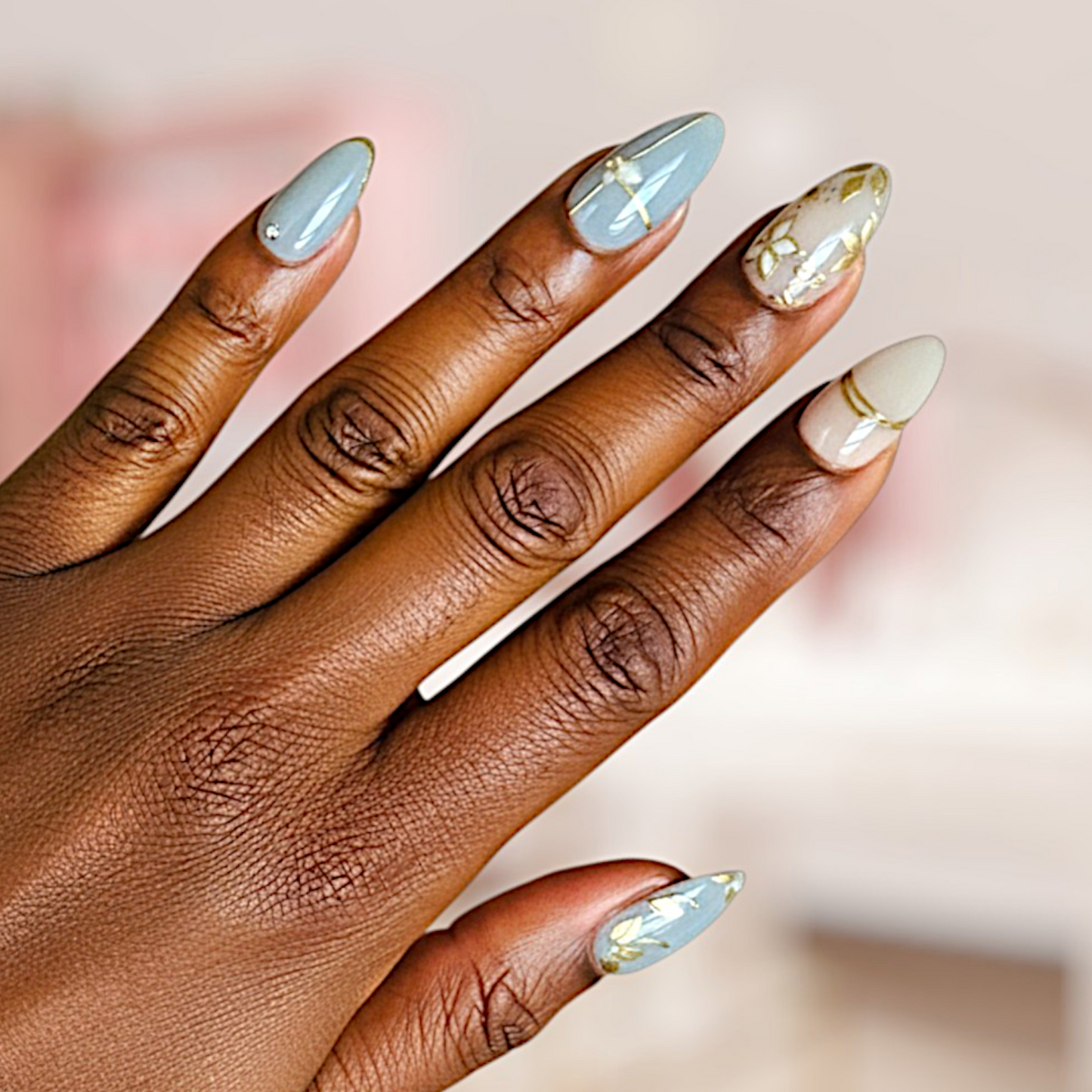 Hand with long, decorated nails on a blurred background