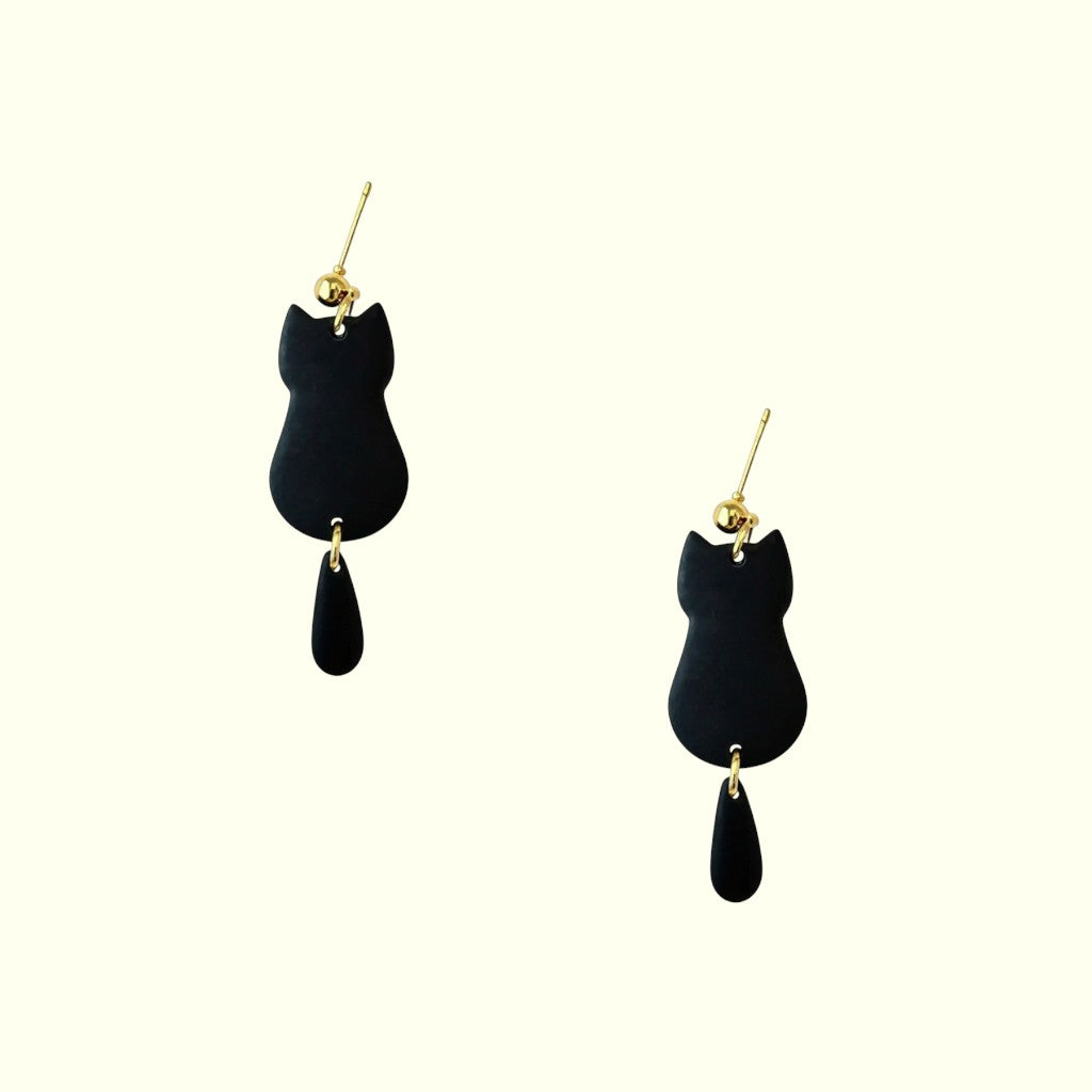 Black cat-shaped earrings with gold accents on a white background