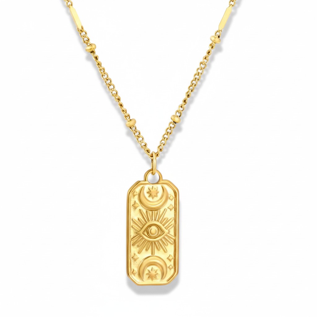 A gold pendant necklace featuring a vertical rectangular tag pendant with embossed celestial and eye motifs, suspended from a gold chain on a white background.