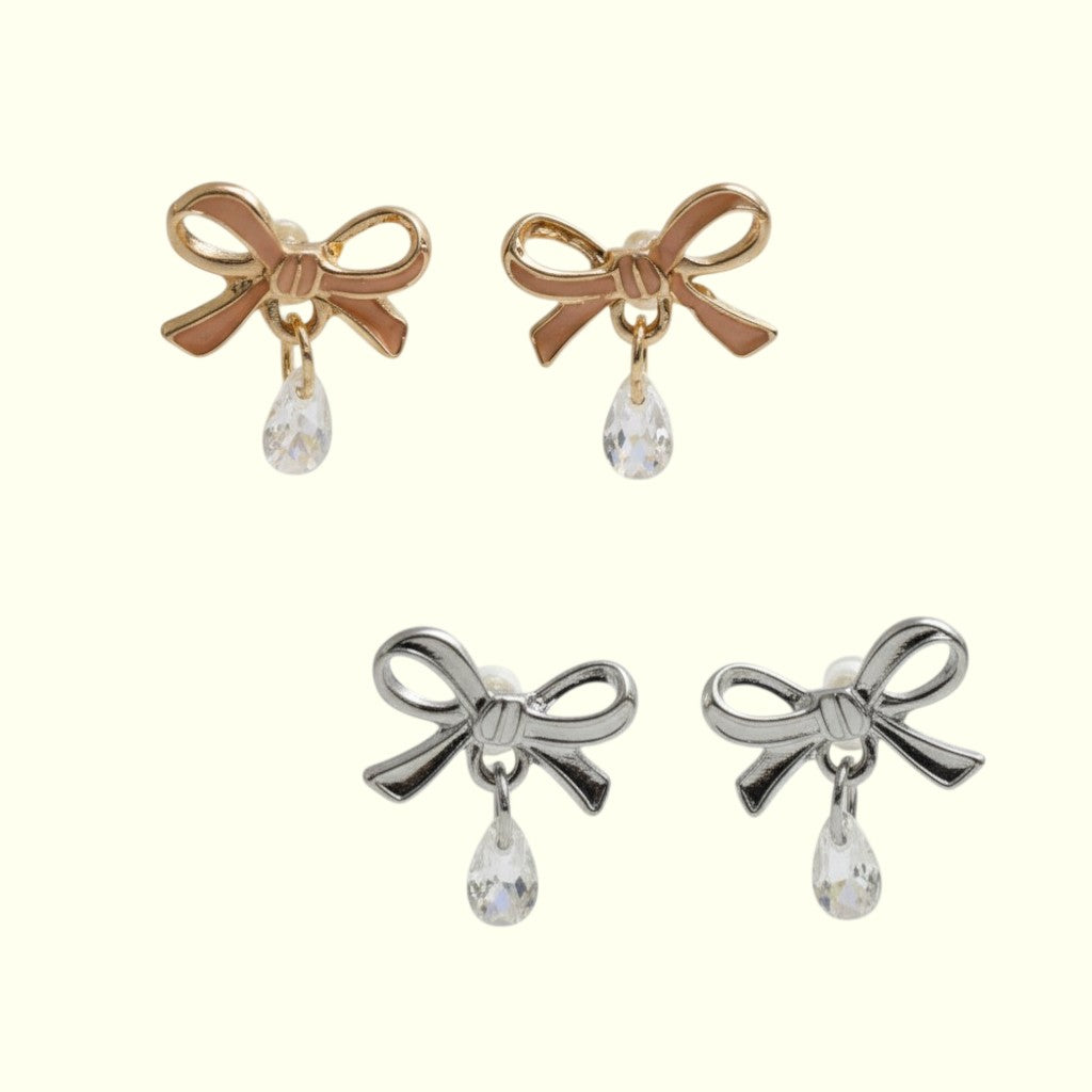 Bow-shaped earrings with teardrop-shaped crystals on a white background