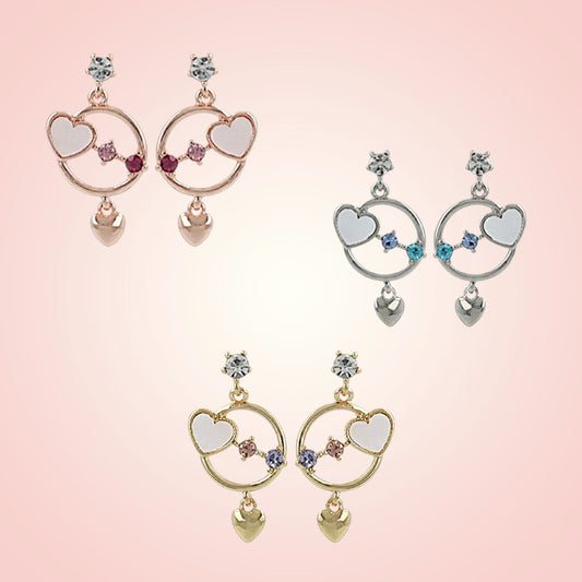 Pair of heart-shaped earrings on a pink background