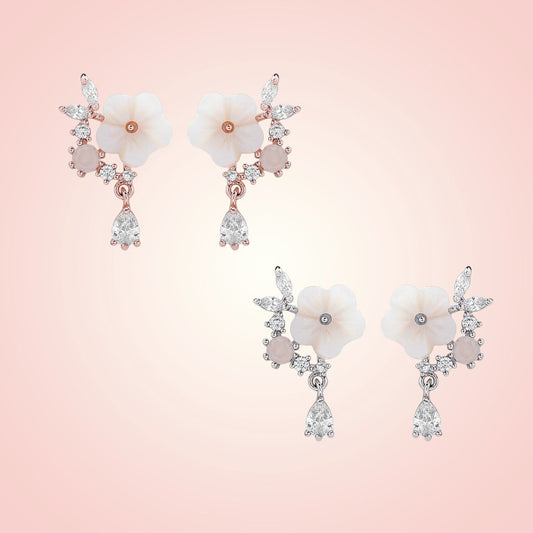 Floral earrings with gemstones on a pink background