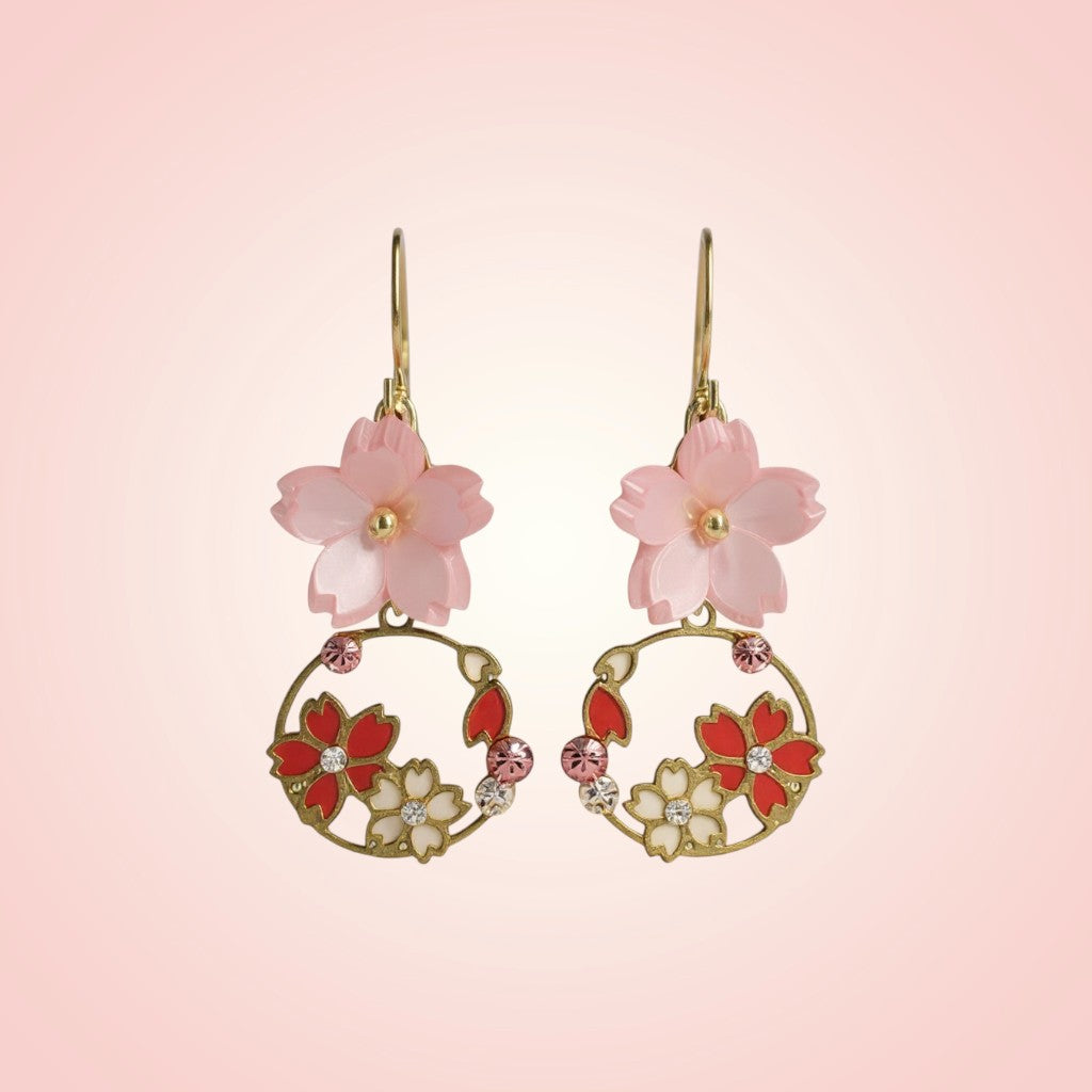 Floral earrings with pink and red flowers on a pink background