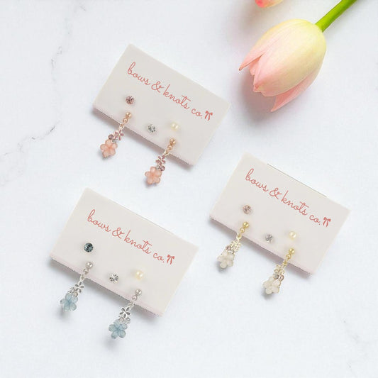 Three pairs of earrings on display cards with 'bows & knots co' branding, set against a light background.