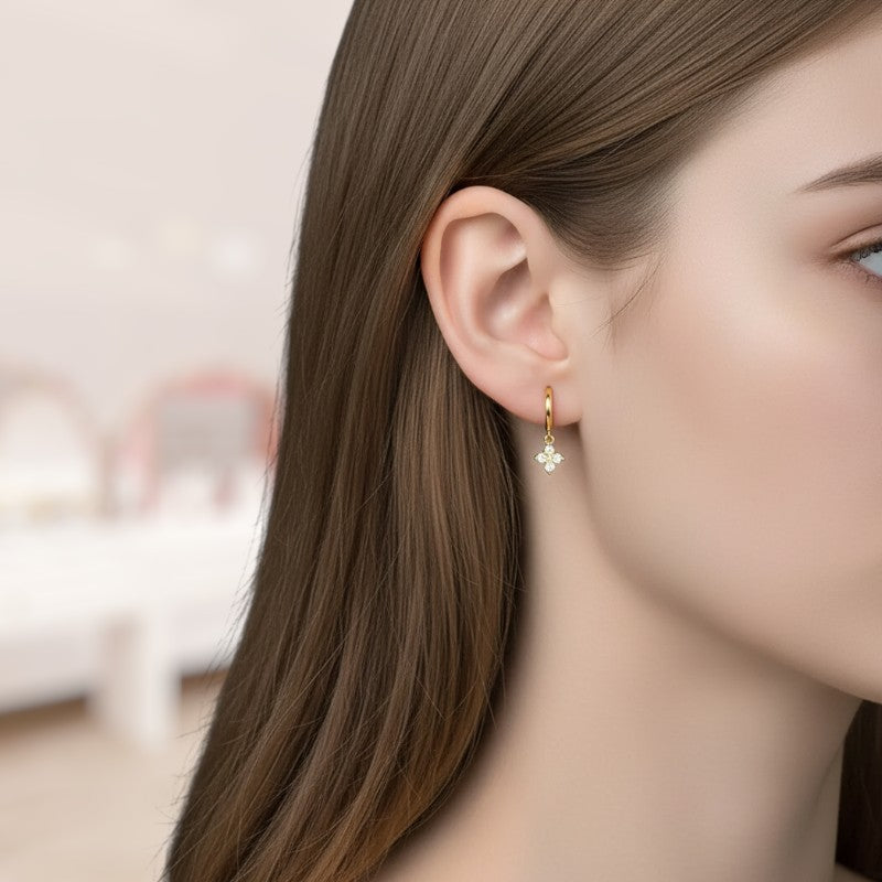 Close-up of a woman wearing gold earrings with a blurred background