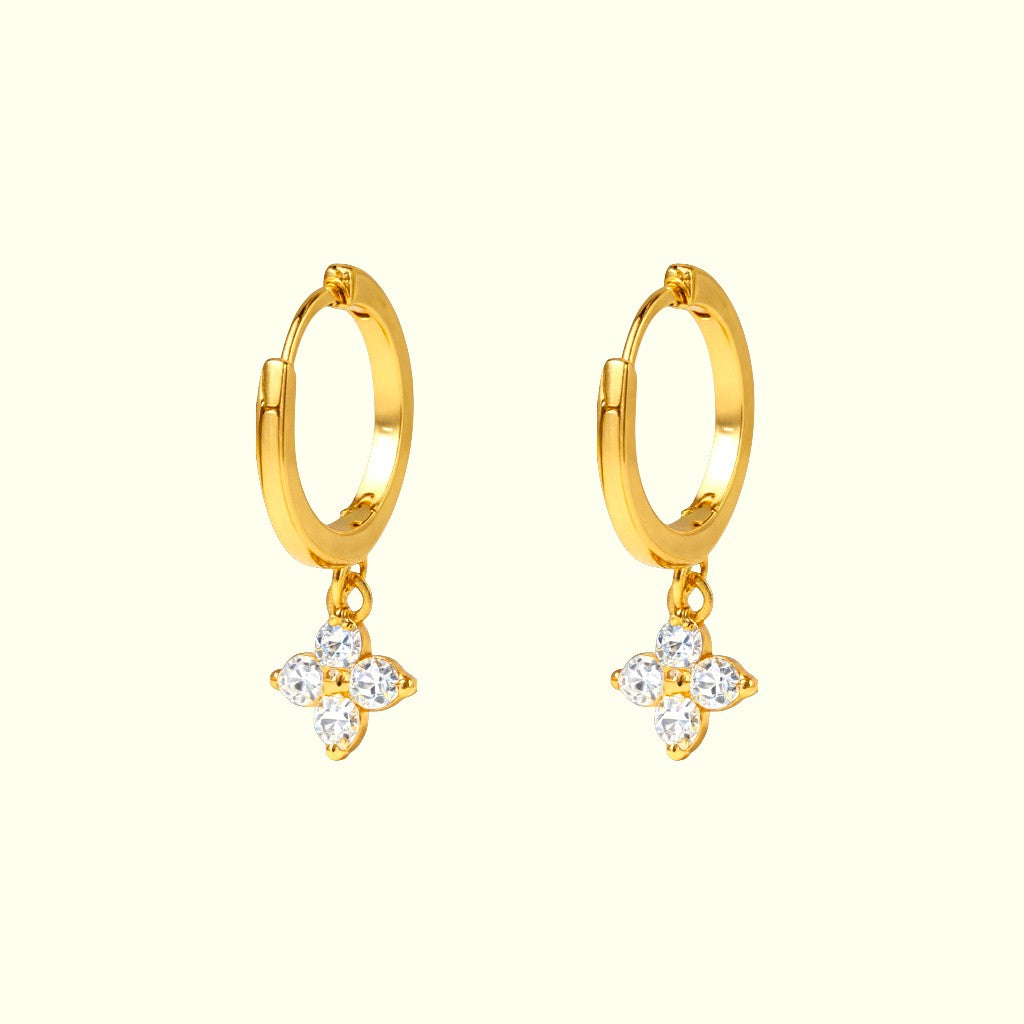 Gold hoop earrings with star-shaped charms on a white background