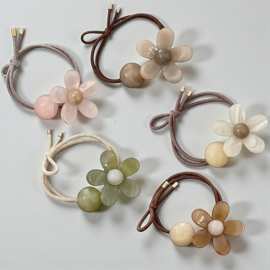Set of floral hair ties on a light gray background
