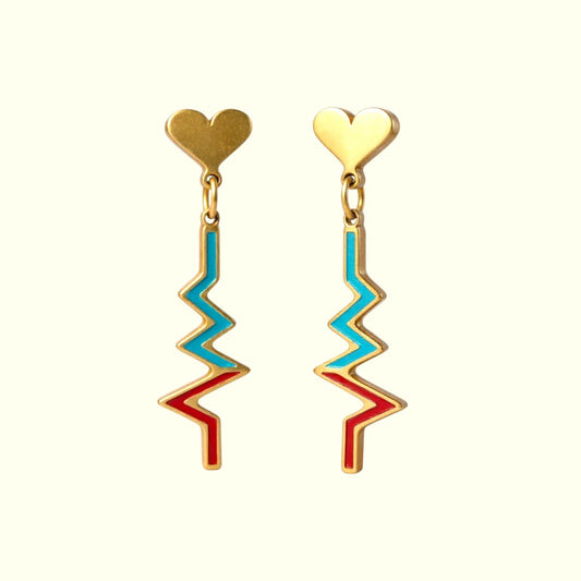 Pair of gold earrings with heart tops and zigzag designs on a white background