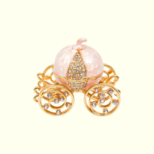 Decorative pumpkin carriage with gold accents on a white background