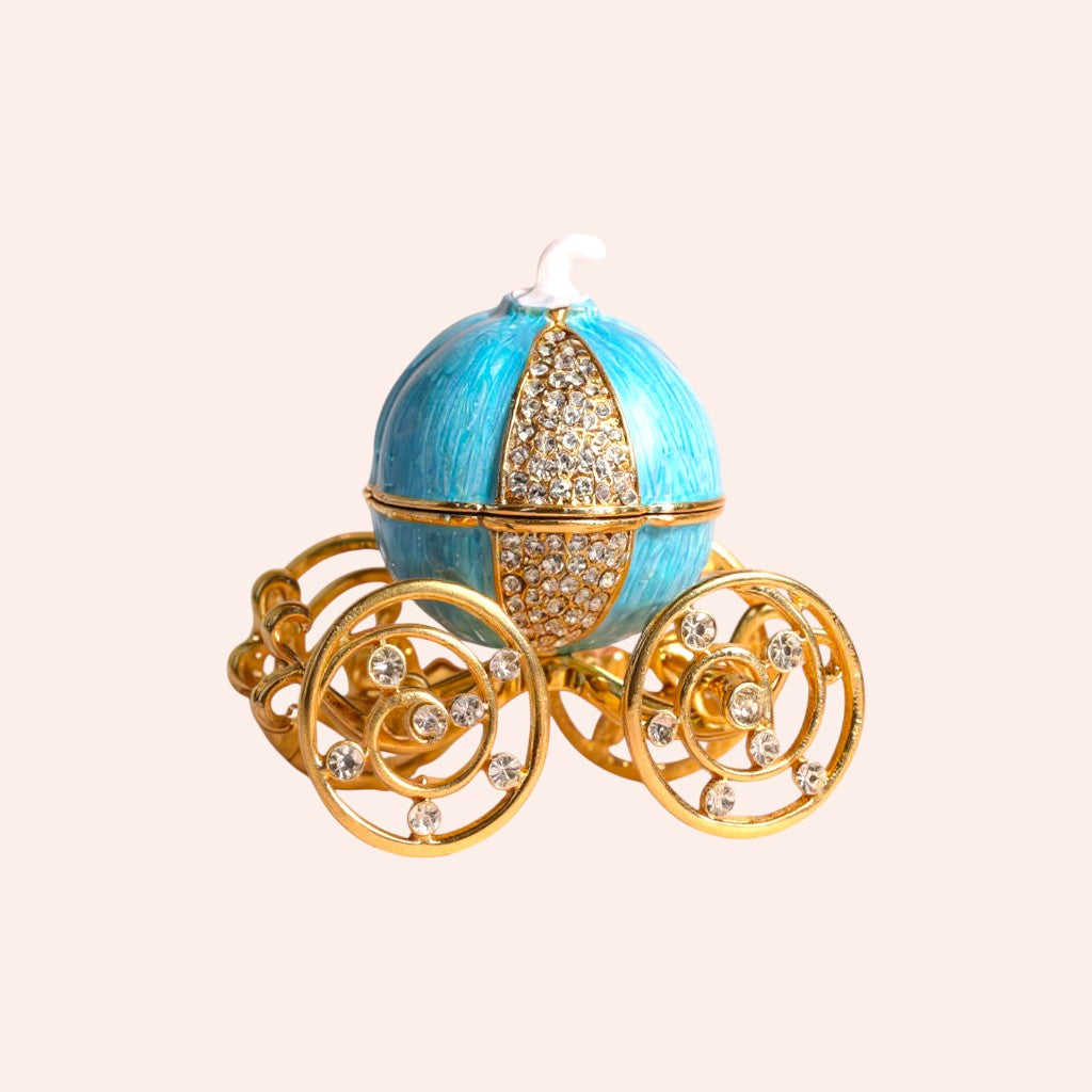 Decorative egg-shaped carriage with blue body and gold wheels on a beige background