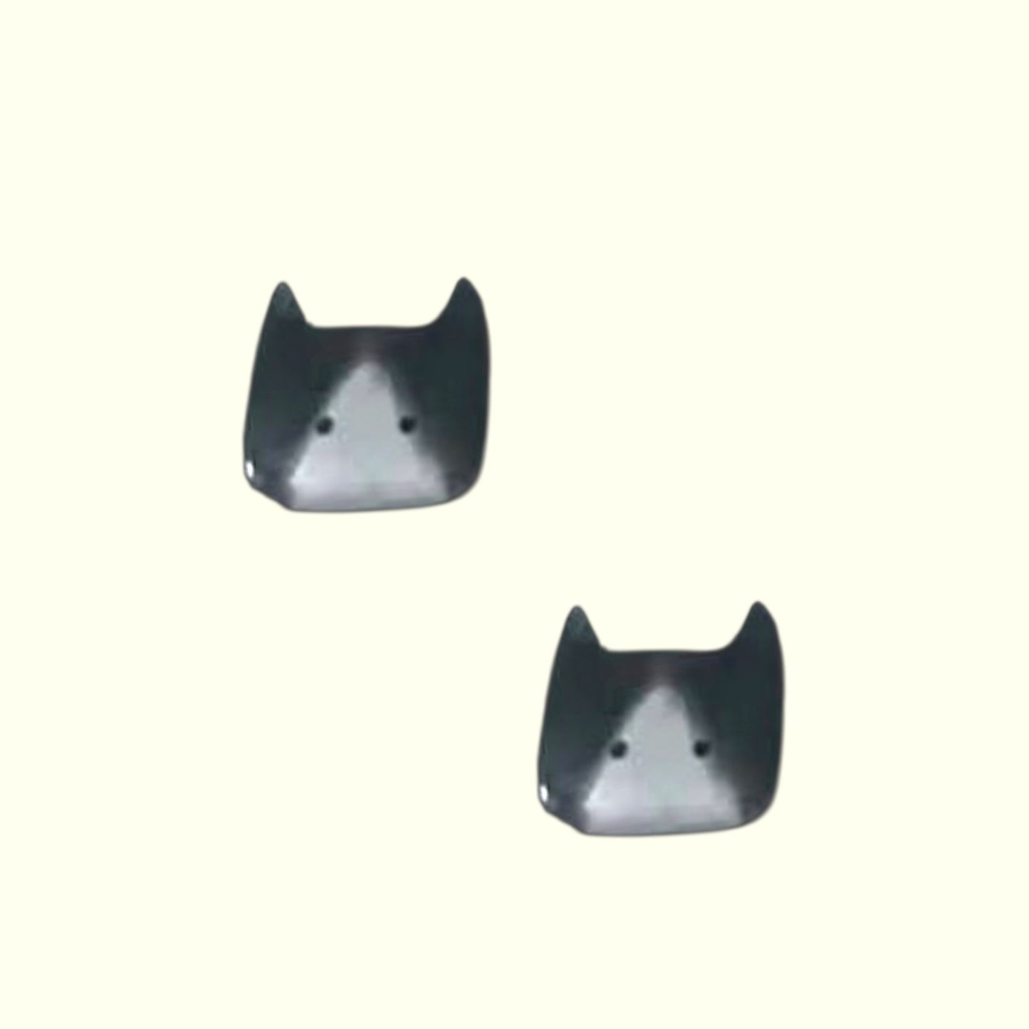 Pair of cat-shaped earrings on a white background