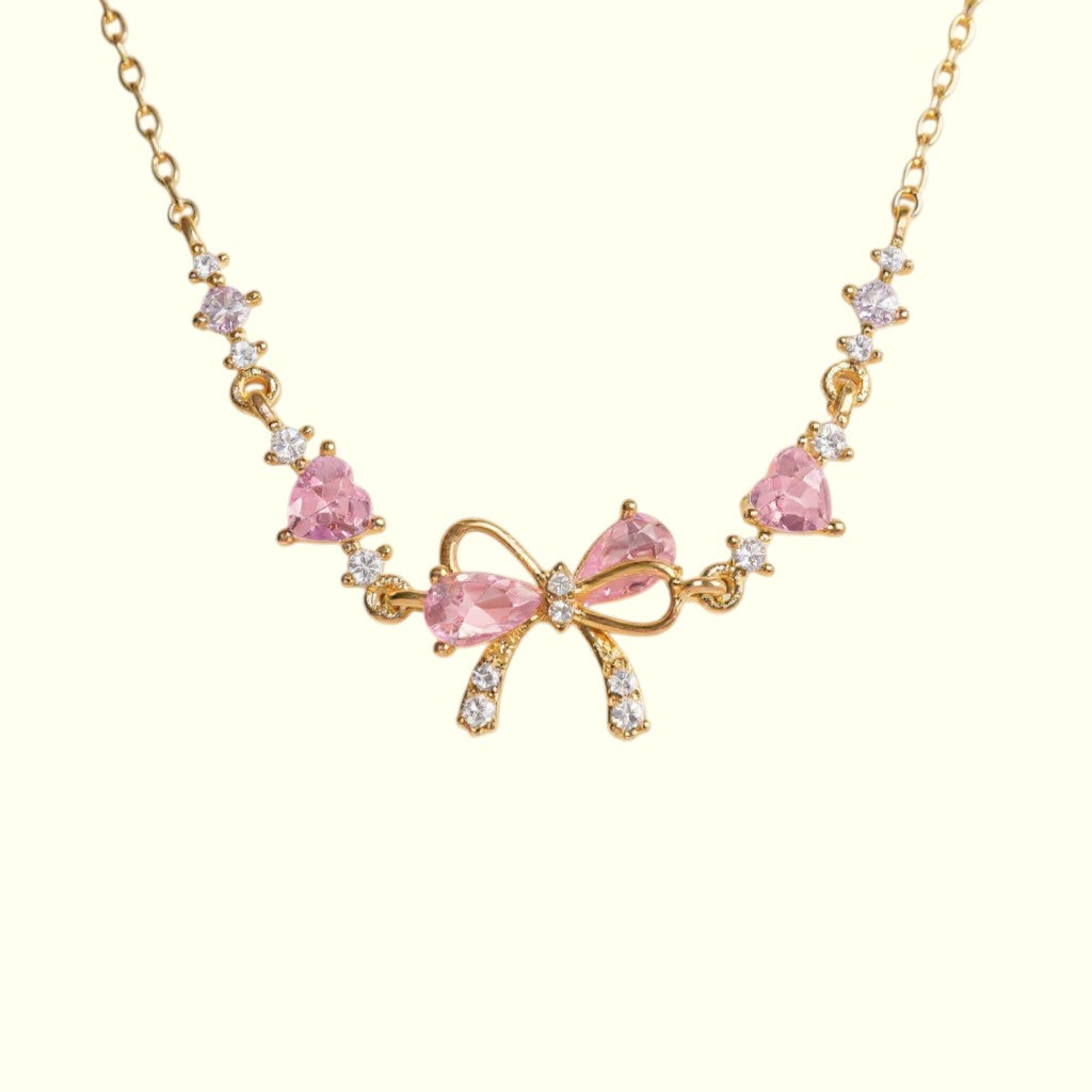 Bracelet with pink bow and gemstones on a white background