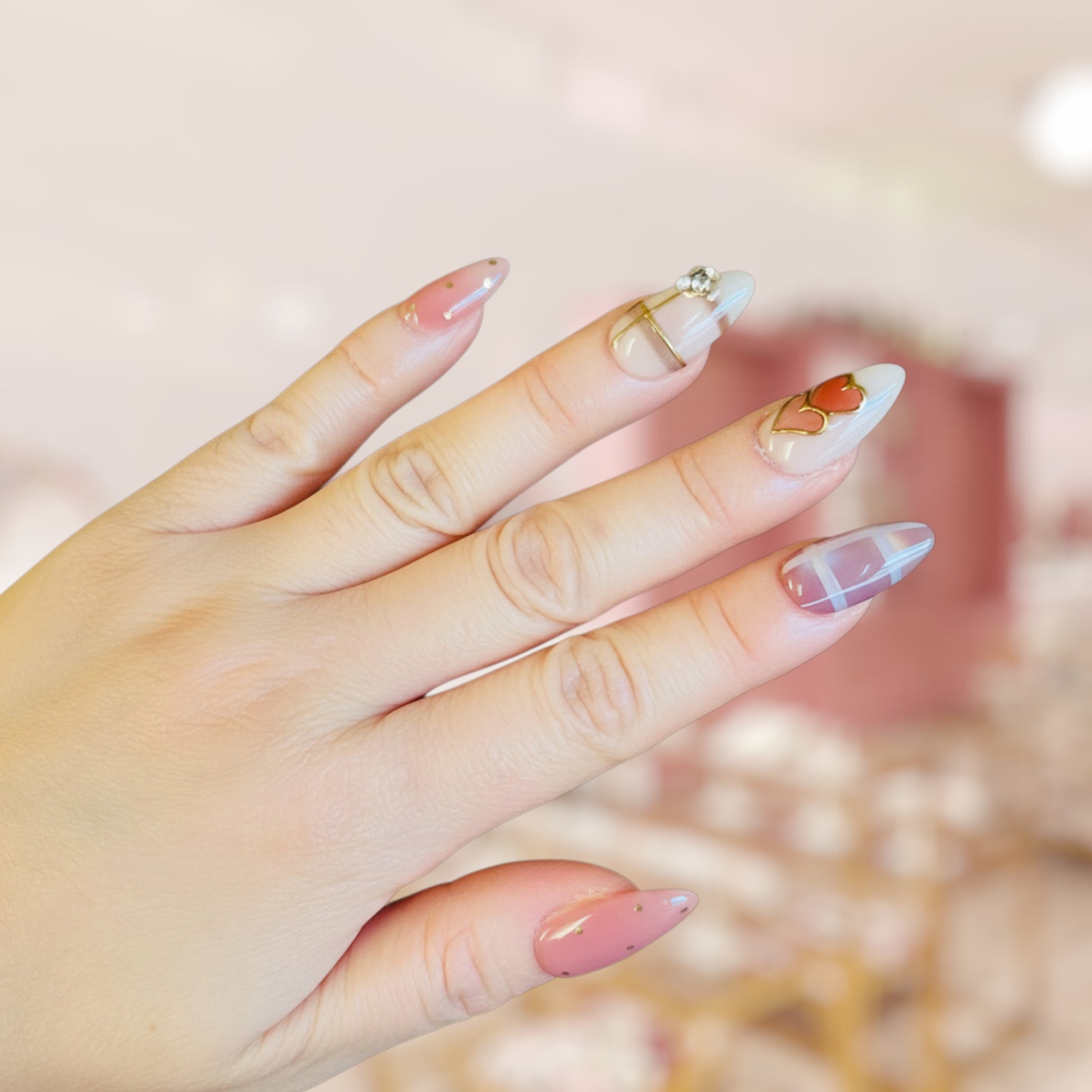 Close-up of a hand with stylish nail art on a blurred background