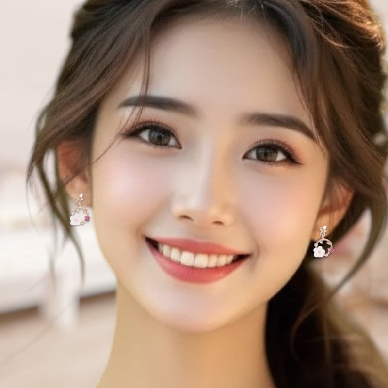 Close-up of a woman wearing earrings with a blurred background