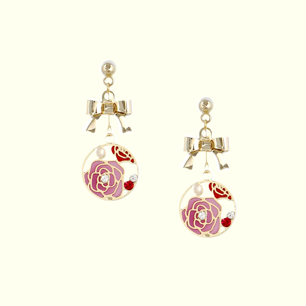 Pair of earrings with floral design on a white background