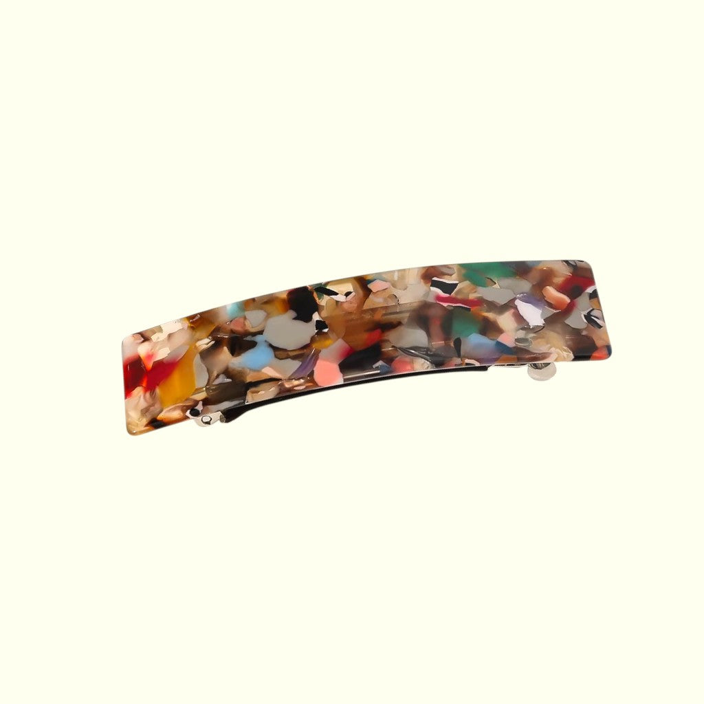 Multicolored rectangular hair clip on a white background