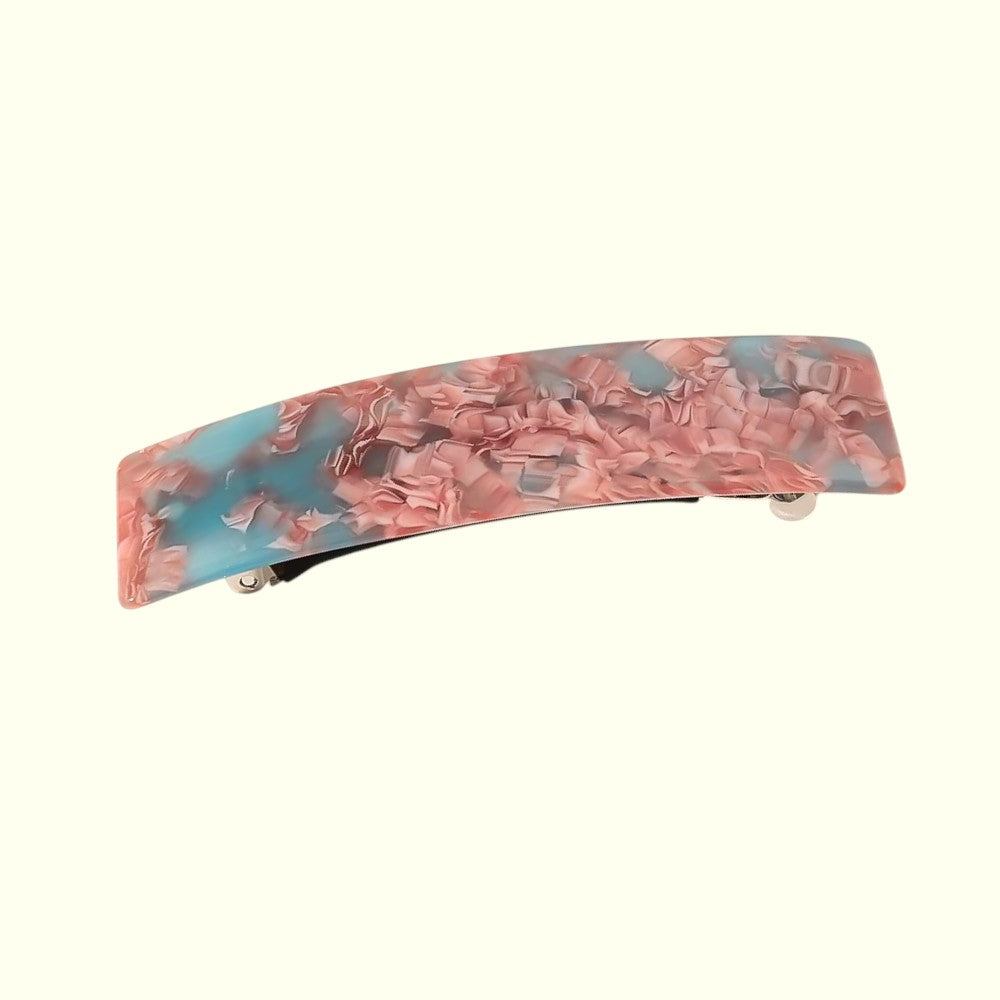 Marbled pink and blue hair clip on a white background