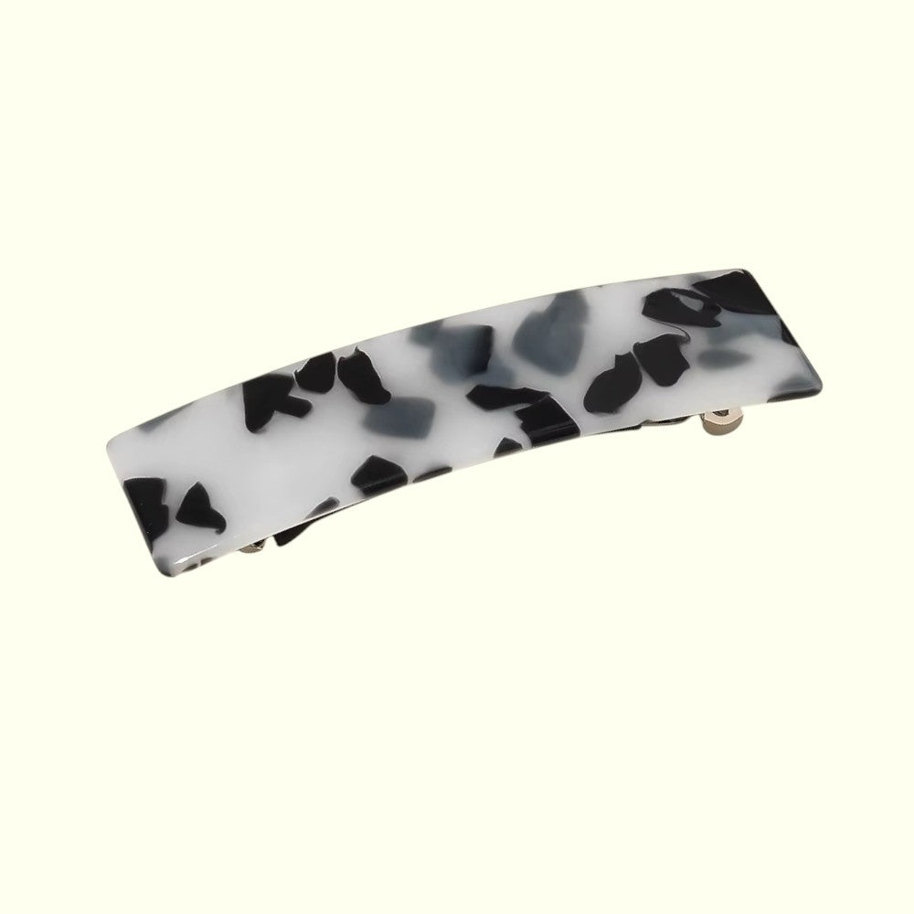 Marbled black and white hair clip on a white background