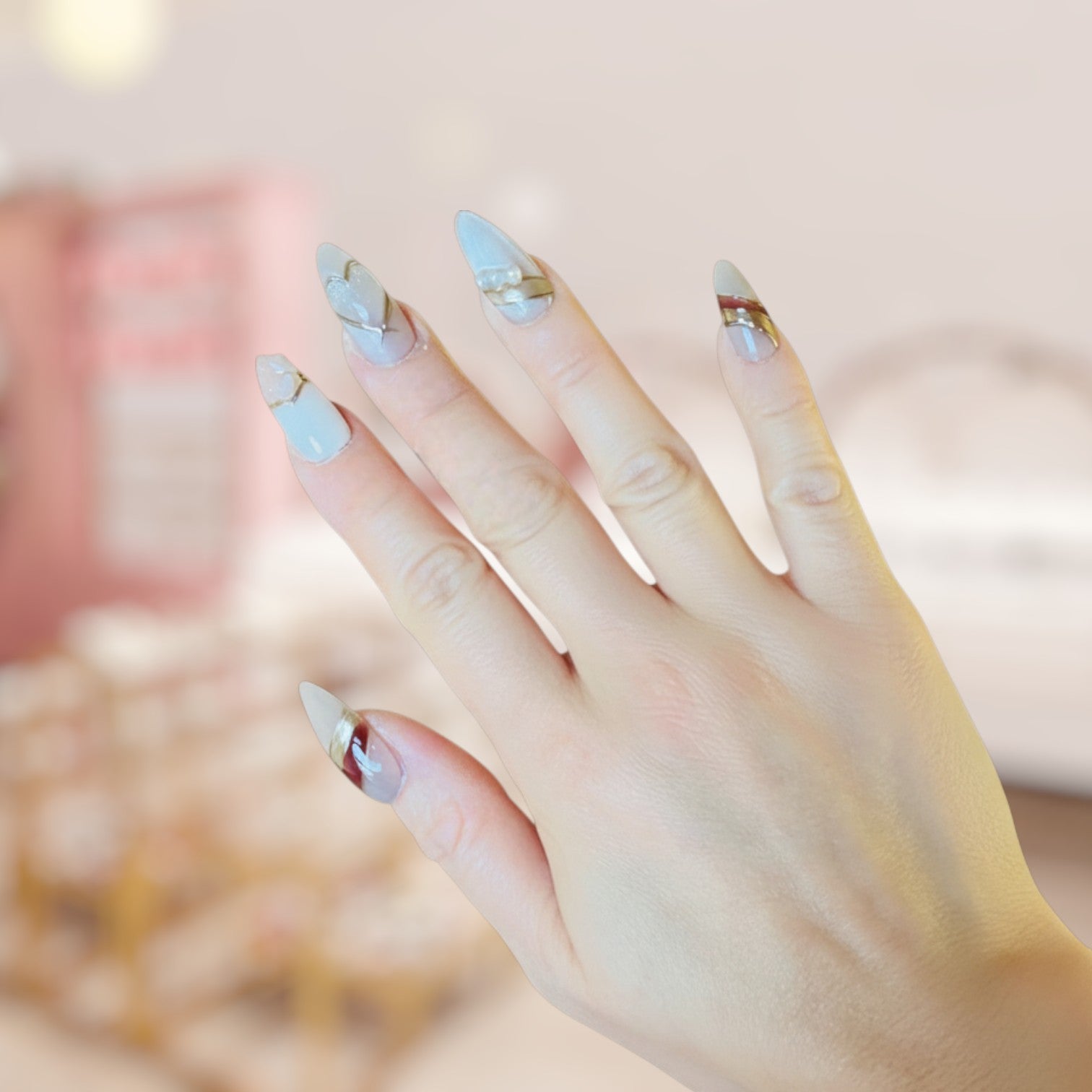 Hand with light blue nail polish on a blurred background