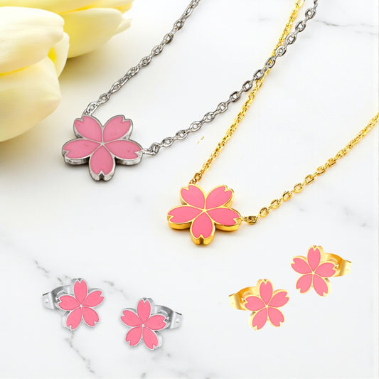 Jewelry set with pink flower pendants on silver and gold chains.