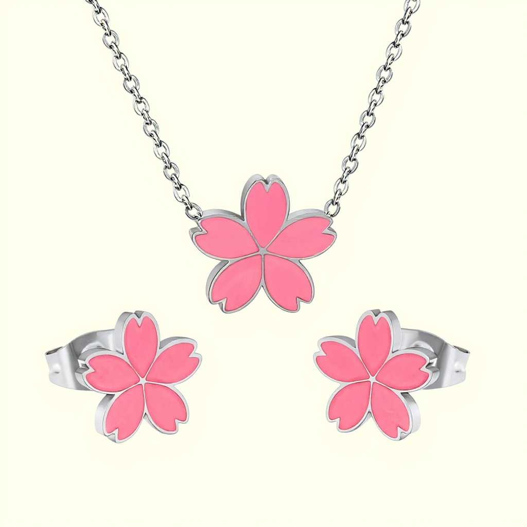 Jewelry set with pink flower-shaped pendants on a white background