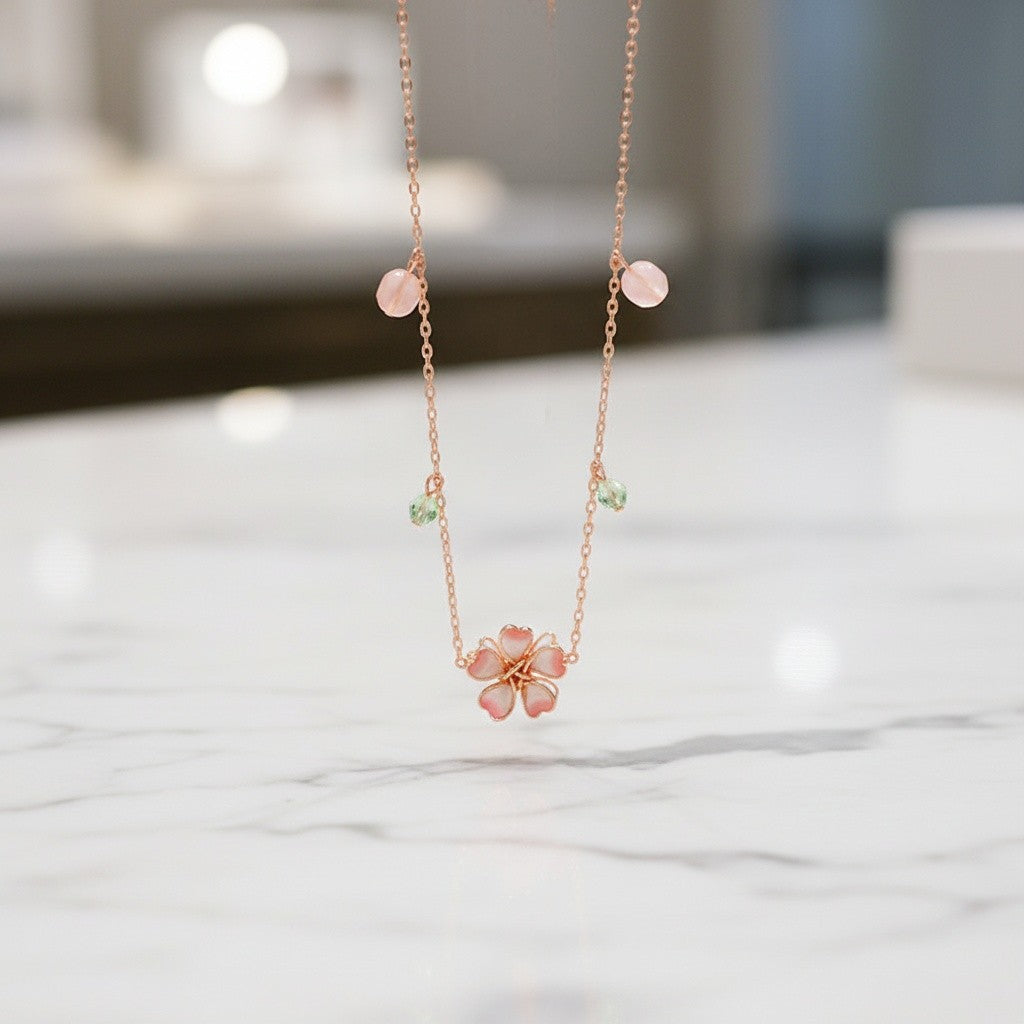 Delicate necklace with a floral pendant on a marble surface