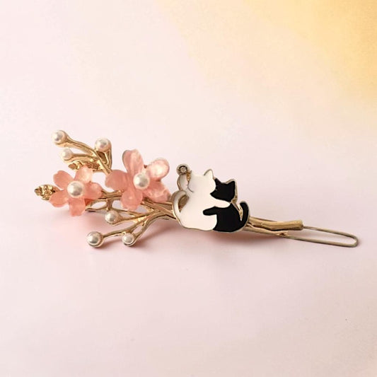Hair clip with floral design and cat silhouette on a pink background