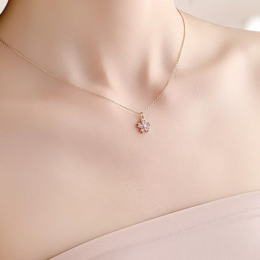 Gold necklace with a floral pendant on a mannequin