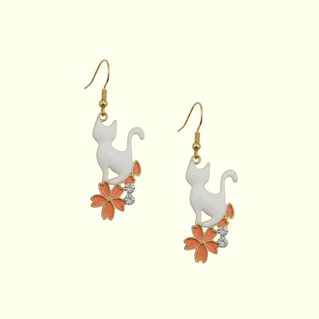 Cat-shaped earrings with floral designs on a white background