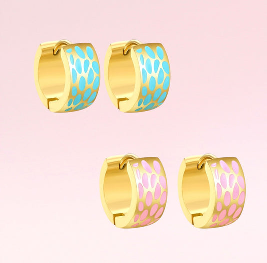 Gold hoop earrings with blue and pink pattern on a pink background