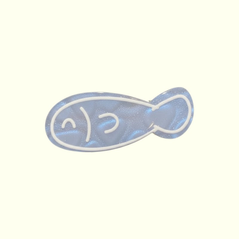 Fish-shaped object with smiley face on a white background