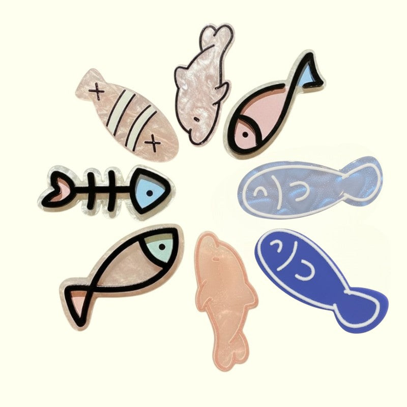 Set of fish-shaped hair clips on a white background