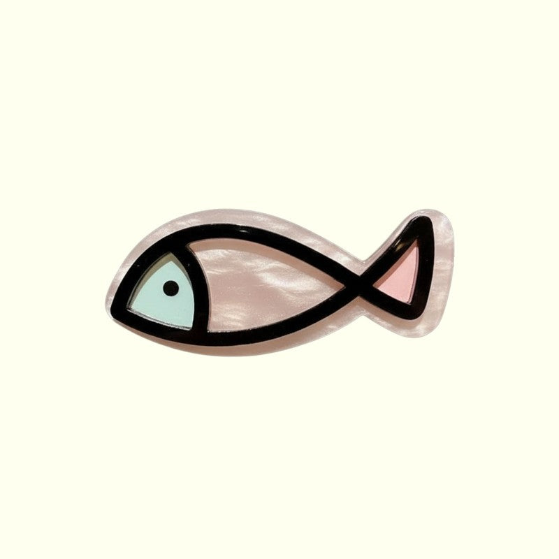 Decorative fish-shaped object with a black outline on a white background