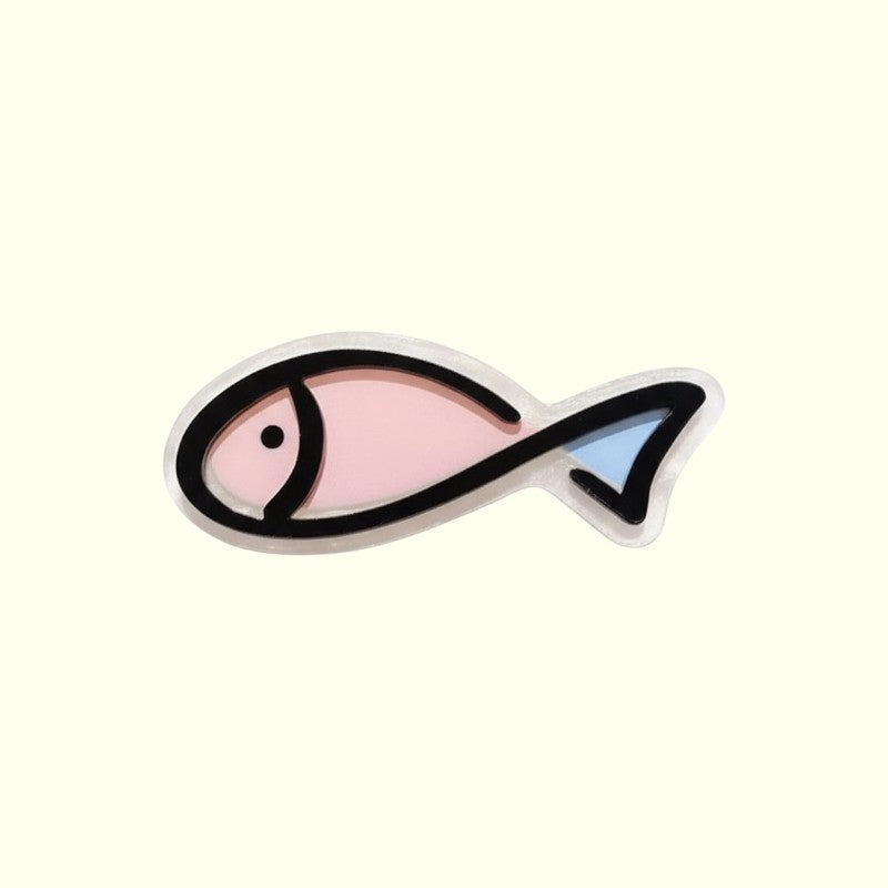 Fish-shaped hair clip with pink body and blue tail on a white background