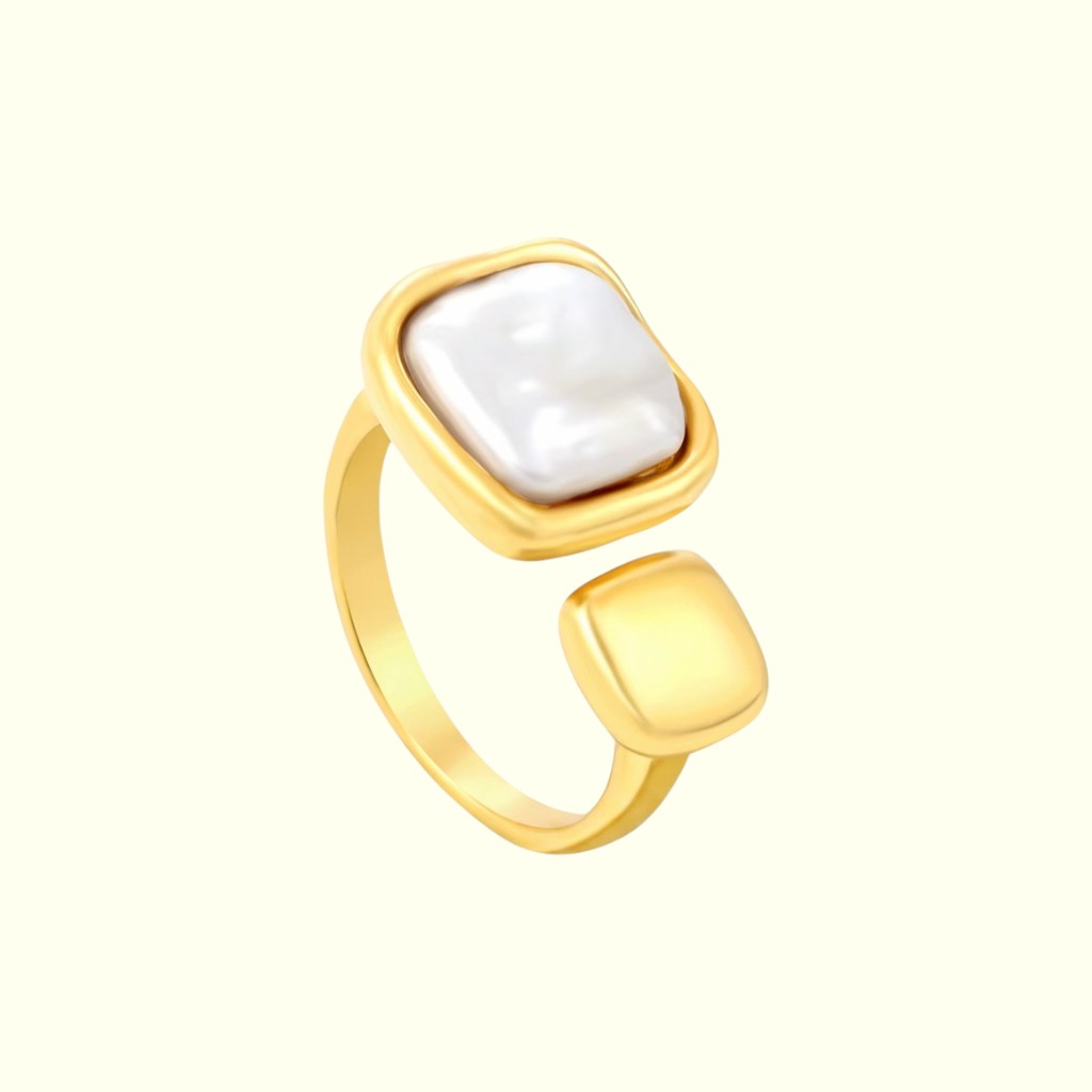 Gold ring with a white pearl on a white background