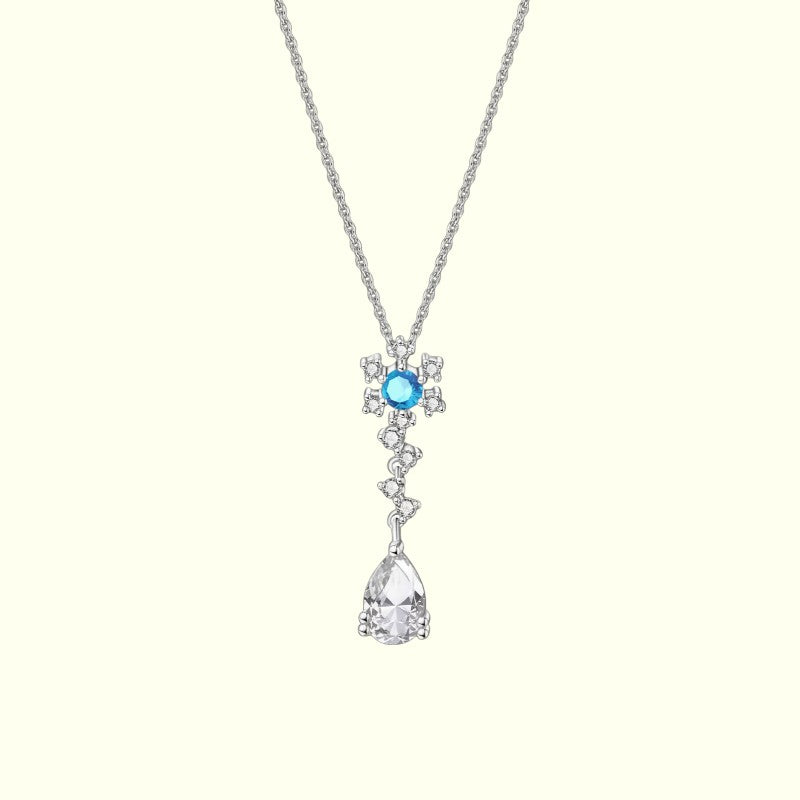 Silver necklace with a blue gemstone and teardrop pendant on a white background